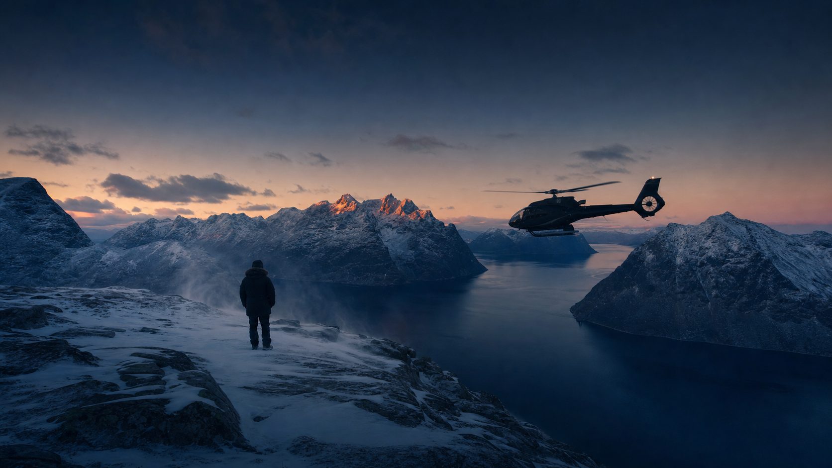 A lone figure in expedition gear stands on a snow-dusted ledge above a Norwegian fjord at blue hour, watching a matte-black helicopter approach across the water.